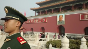 A guard stands near the Gate of Heavenly Peace and its giant picture of Mao. Photo by D. Dina Friedman.