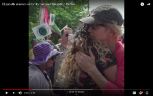 Elizabeth Warren hugs a woman in front of Homestead Detention Center