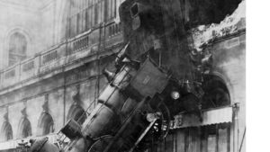 Steam locomotive falling through a railway station wall